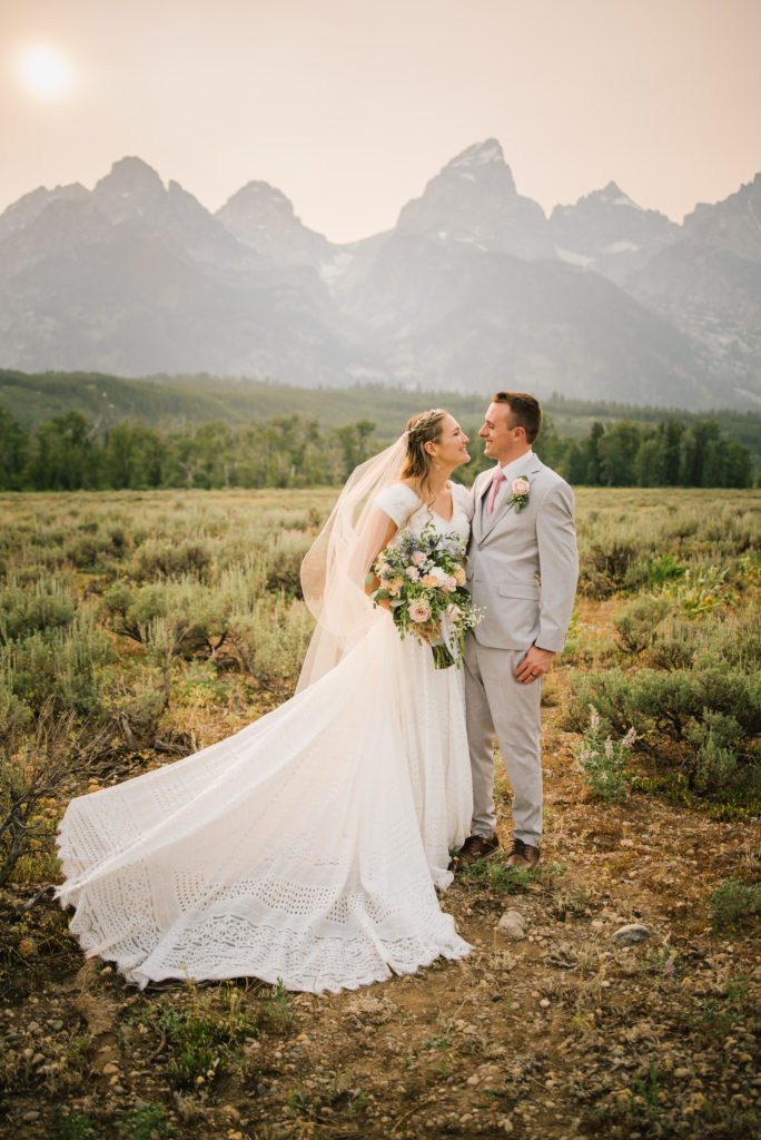 Jackson Hole wedding photographer captures bride and groom wearing wedding attire during portraits