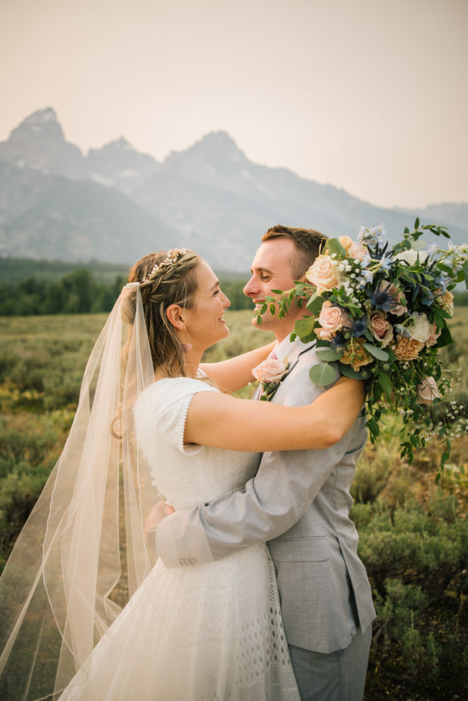 Jackson Hole wedding photographer captures couple embracing after Grand Teton wedding