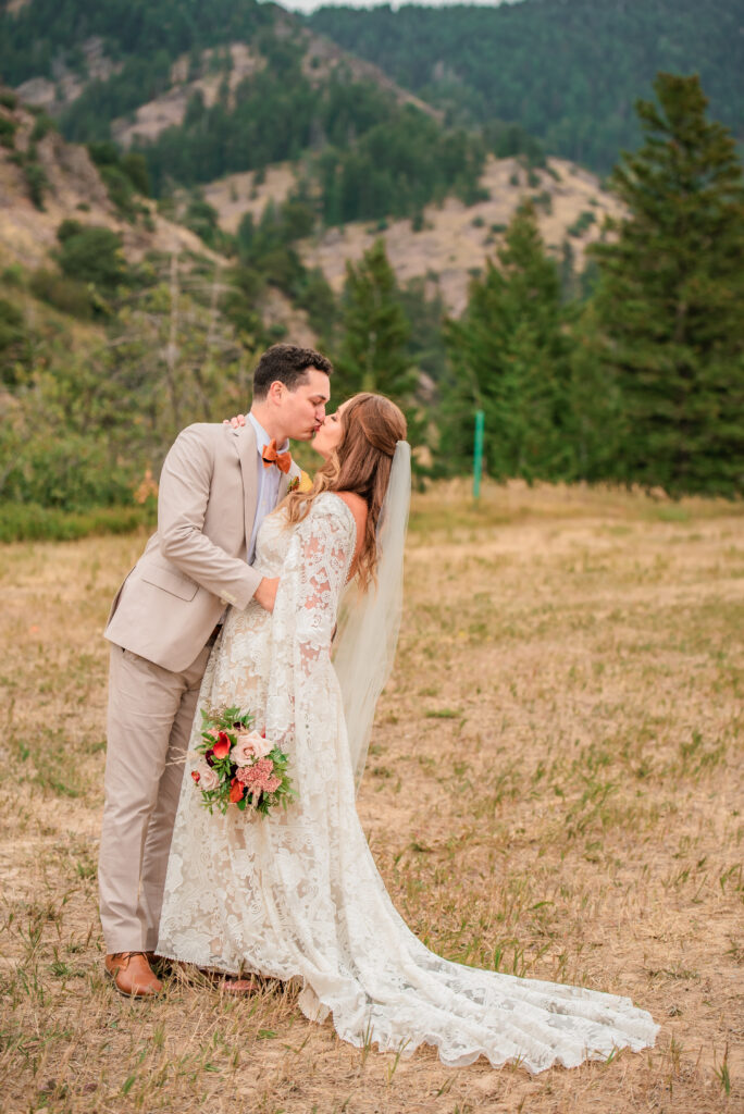 Jackson Hole elopement photographer captures bride and groom kissing after first look