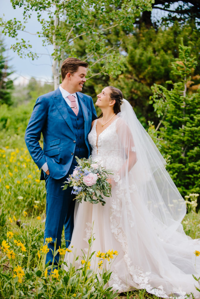 Jackson Hole wedding photographers capture bride and groom looking at one another during outdoor portraits