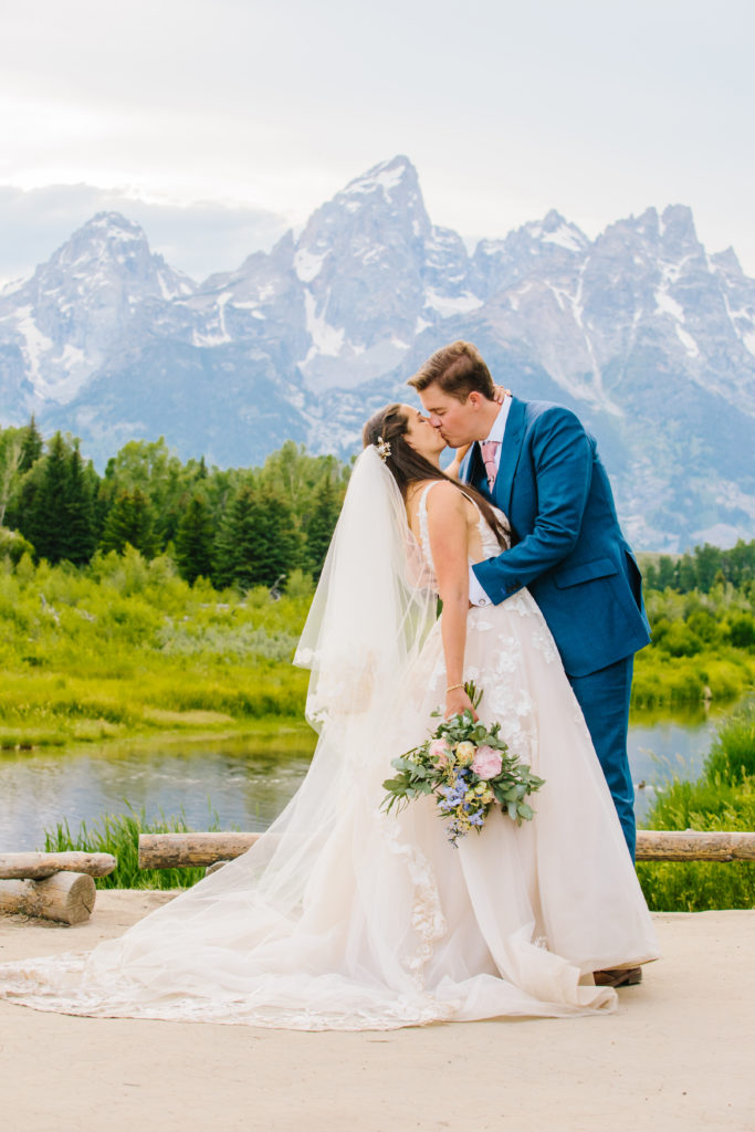 Jackson Hole wedding photographer captures bride and groom kissing 