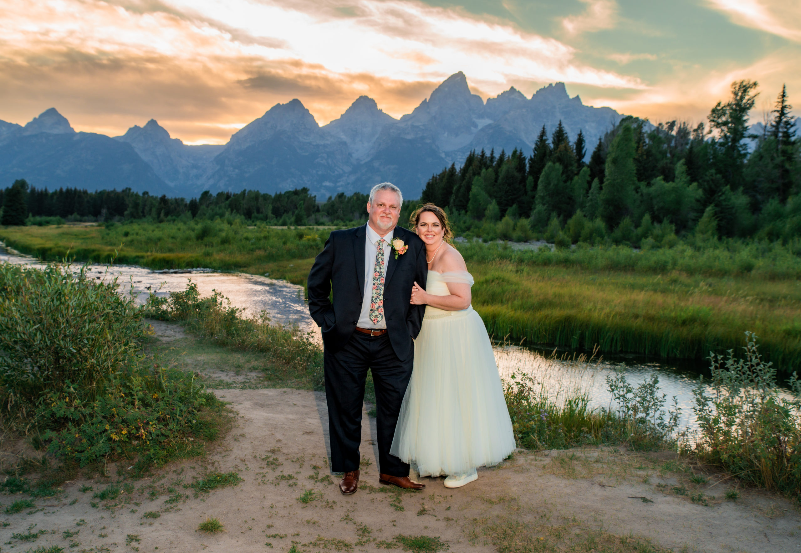 Grand Teton wedding photographer captures couple embracing during sunset portraits