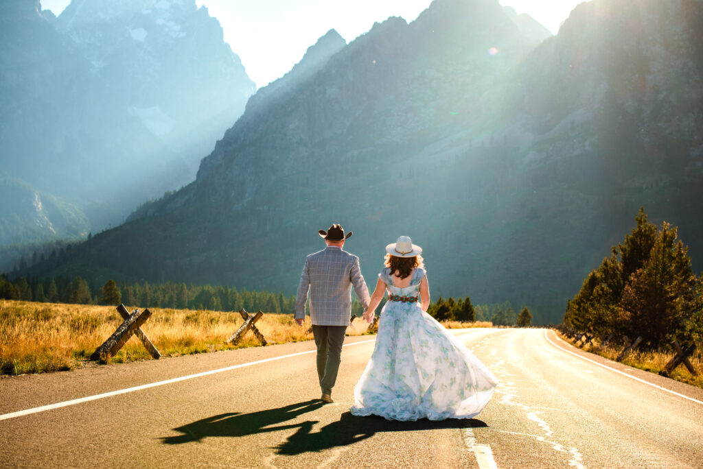 Jackson Hole wedding photographer captures newly married couple walking together after sustainable Grand Teton wedding