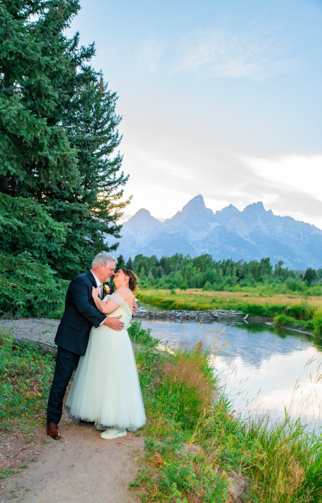 Jackson Hole photographer captures bride and groom embracing after Schwabacher's Landing Summer Elopement