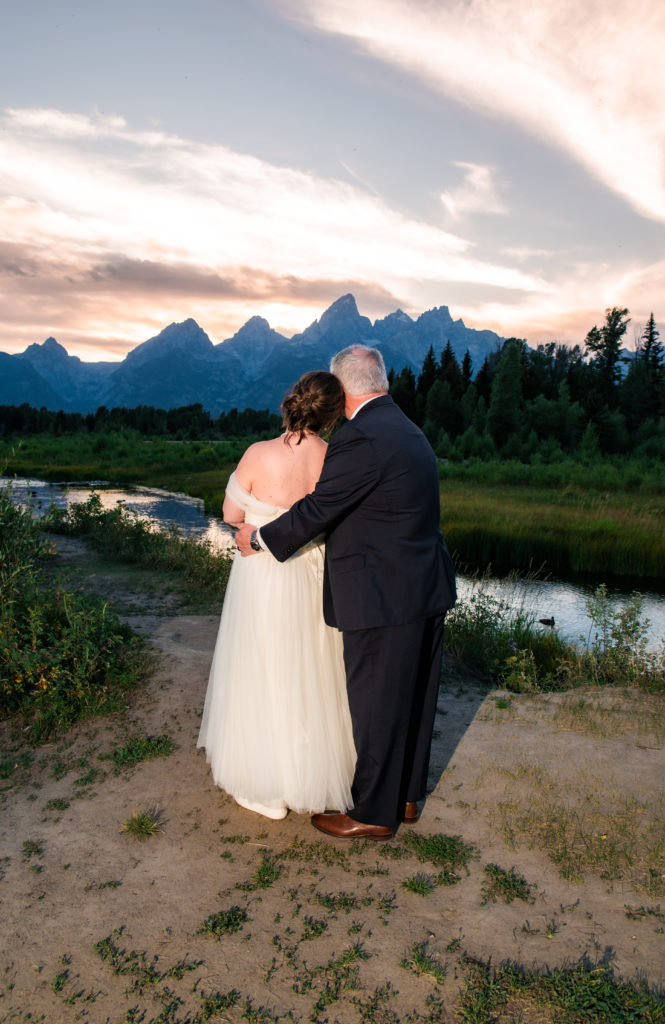 Jackson hole photographer captures bride and groom watching sunset after Schwabacher's Landing Summer Elopement