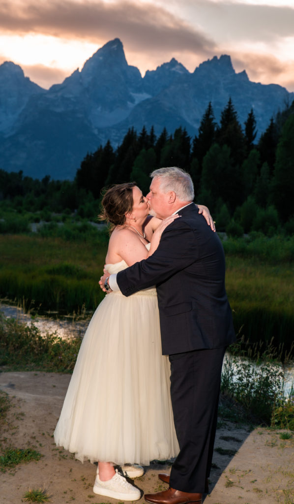 Jackson Hole elopement photographer captures couple kissing at sunset after Schwabacher's Landing Summer Elopement