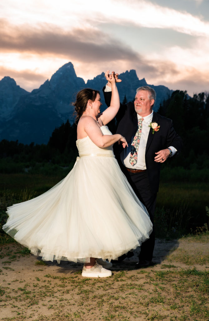Jackson Hole elopement photographer captures newly married couple dancing during sunset