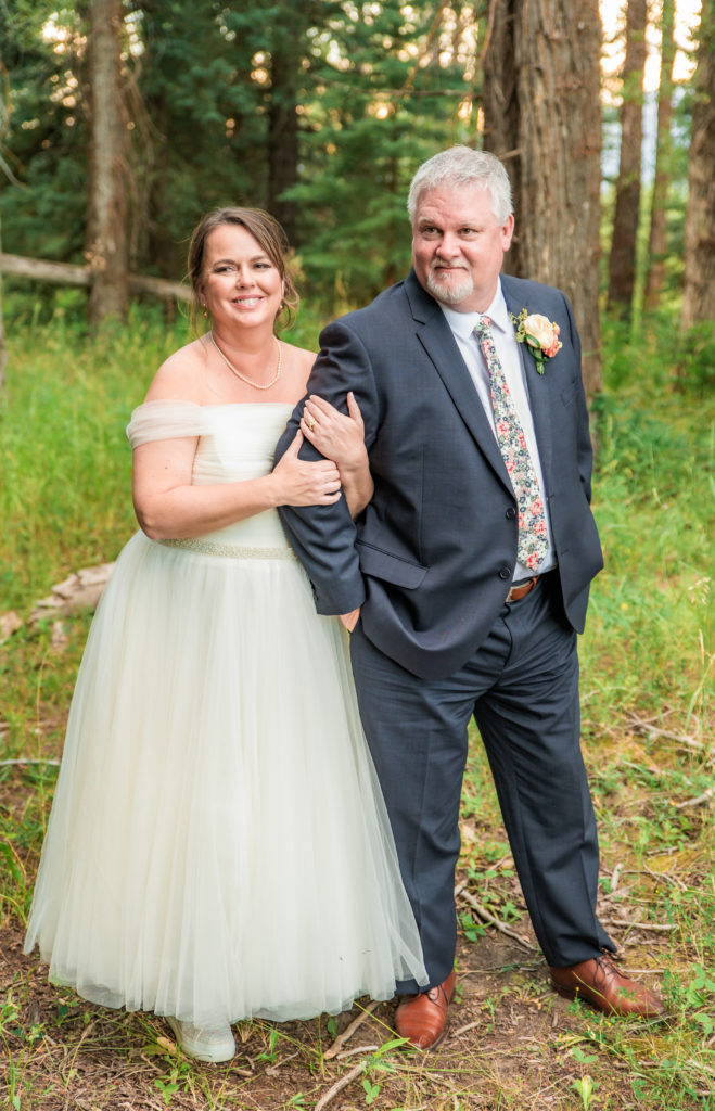 Jackson Hole photographer captures couple standing together wearing wedding attire 