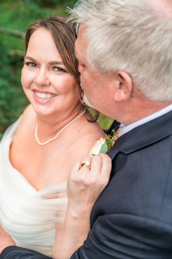 Jackson Hole photographer captures groom kissing bride's cheek