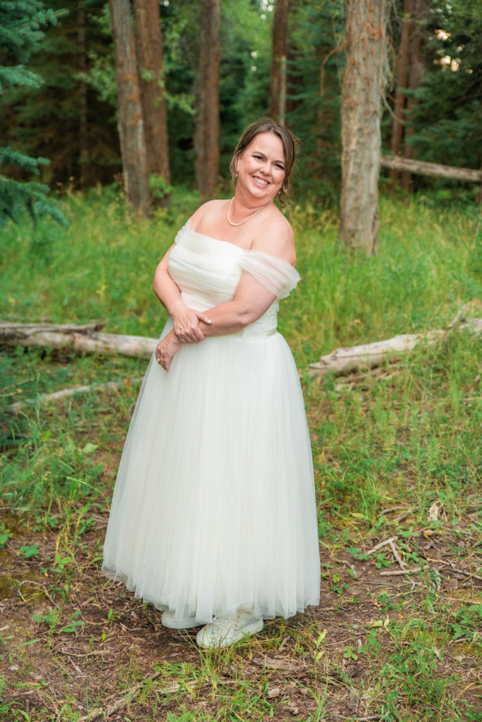 Jackson Hole photographer captures bride wearing off the shoulder wedding dress 