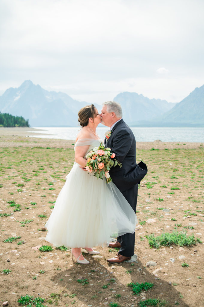 Jackson Hole elopement photographer captures bride and groom kissing as husband and wife