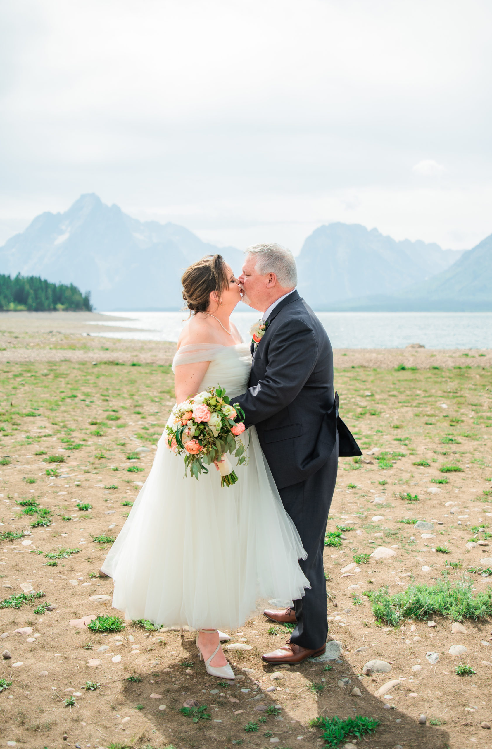 Jackson Hole elopement photographer captures bride and groom kissing after wedding ceremony