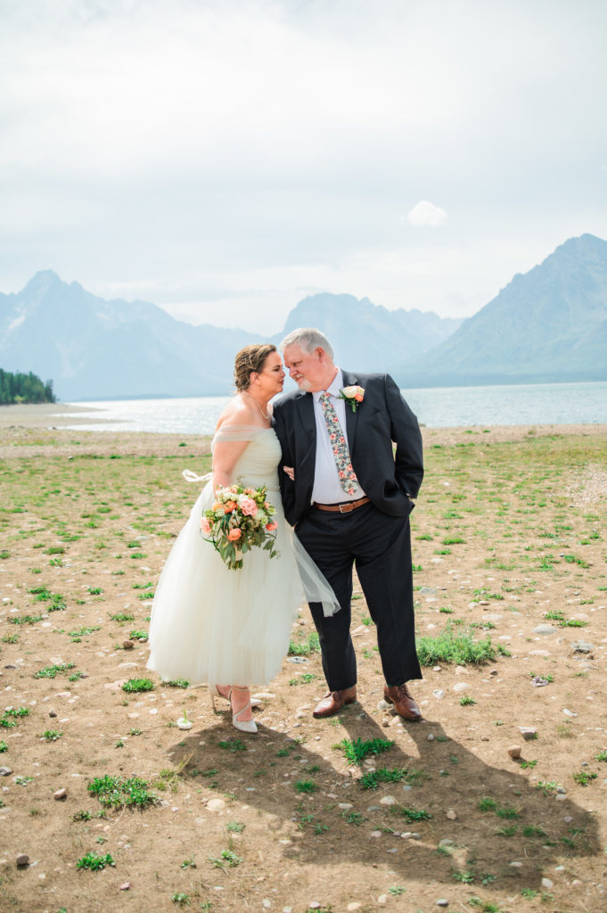 Jackson Hole elopement photographer captures bride and groom celebrating after elopement ceremony