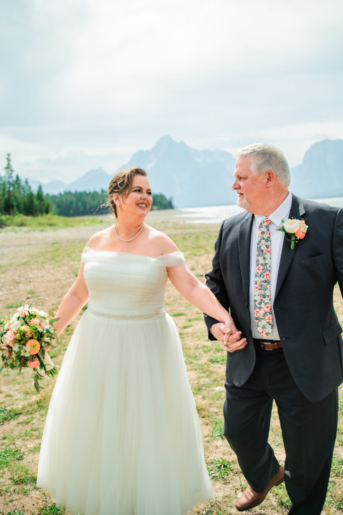 Jackson Hole elopement photographer captures bride and groom walking together after Windy Colter Bay Elopement