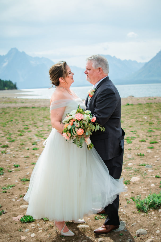 Jackson Hole elopement photographer captures bride and groom looking at one another after grand teton wedding