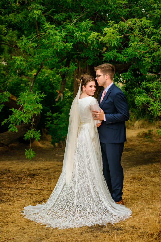 Jackson Hole wedding photographers capture bride and groom embracing during wedding travel in Jackson Hole 