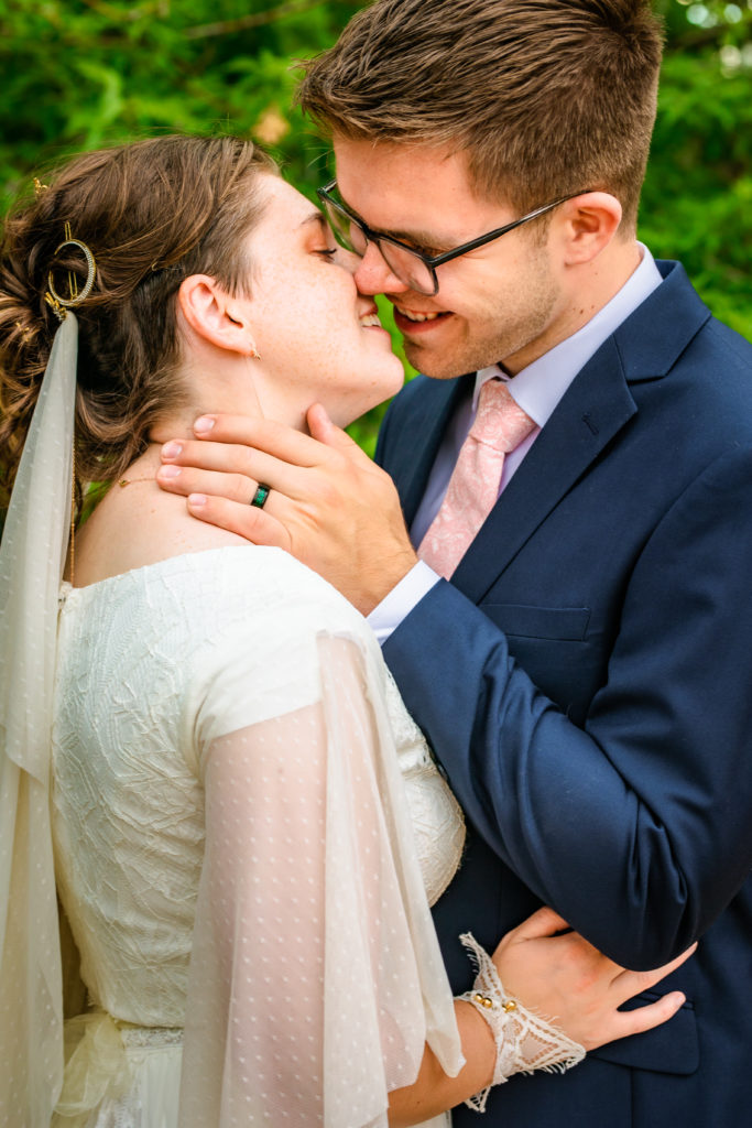 Jackson Hole wedding photographers capture couple kissing during wedding portraits 