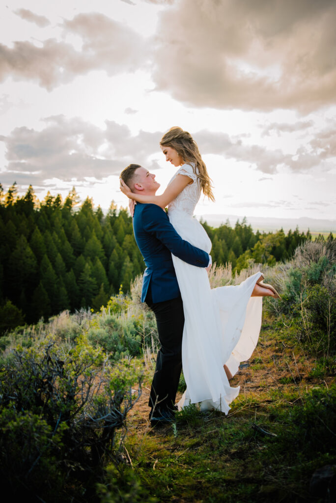 Jackson Hole elopement photographer captures groom lifting bride during jackson hole elopement