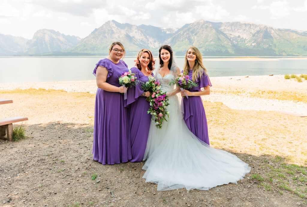 Jackson Hole photographers capture bride standing with bridesmaids during Grand Teton wedding