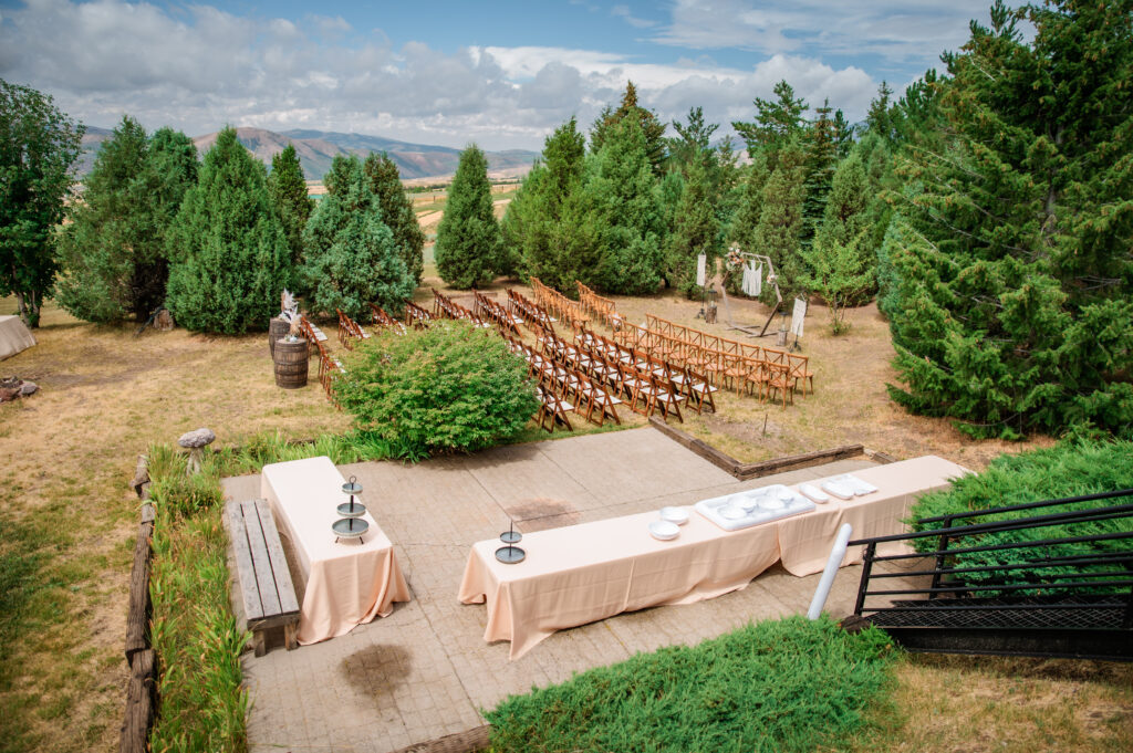 Jackson Hole Wedding ceremony site set up among thick trees and the moutnains.