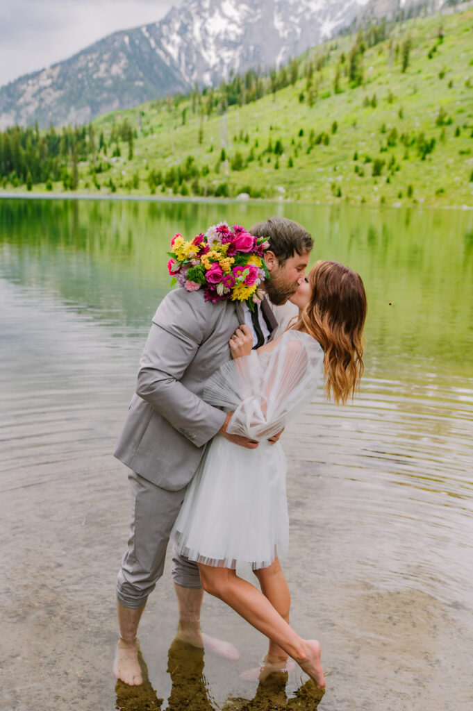 Jackson Hole photographers capture couple kissing in water after Jackson Hole elopement