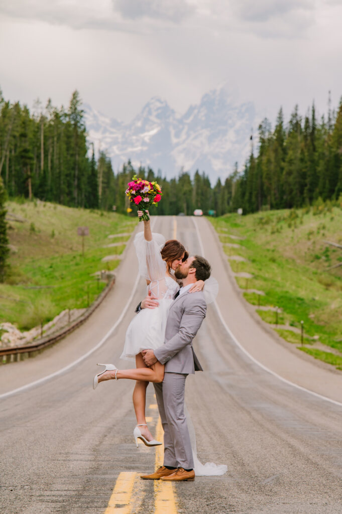 Jackson Hole photographers capture couple celebrating eloping by kissing in street