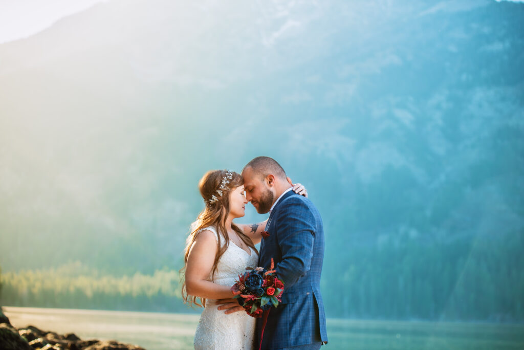 Bride and groom put foreheads together at their Fall elopement in Jackson Hole at Sting Lake.
